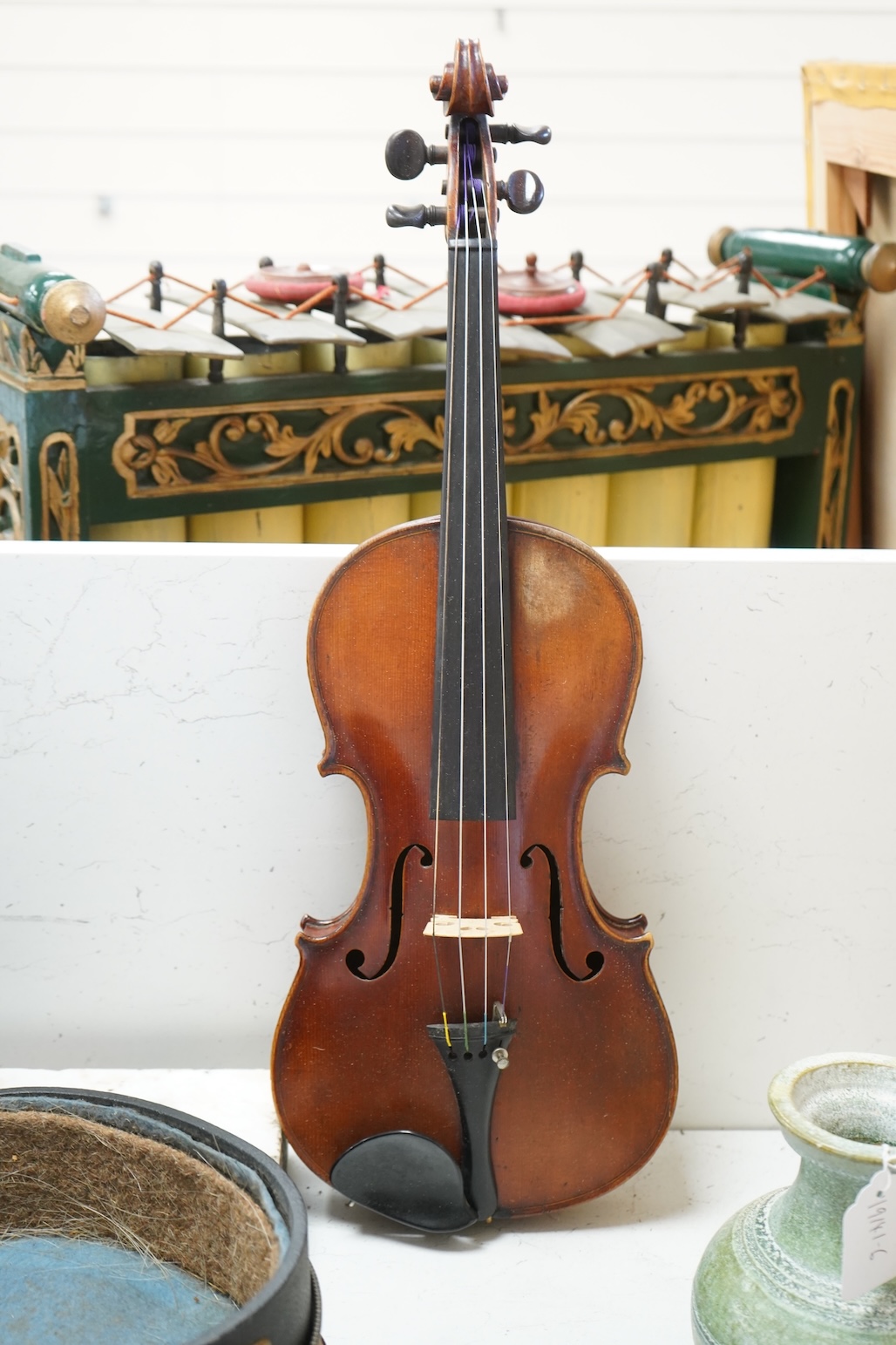 An early 20th century cased violin and cover, 60cm long